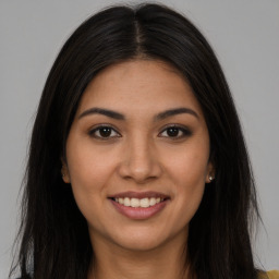 Joyful latino young-adult female with long  brown hair and brown eyes