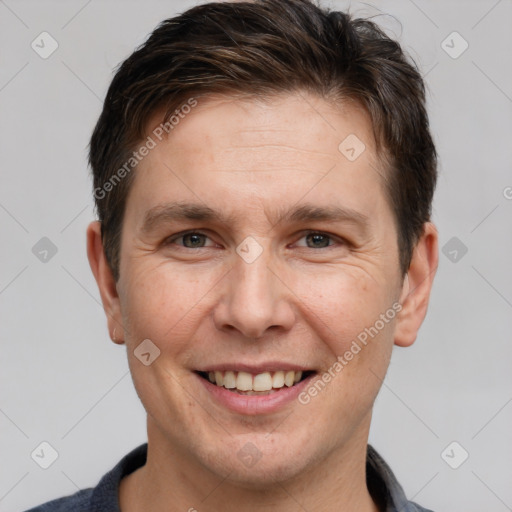 Joyful white adult male with short  brown hair and grey eyes