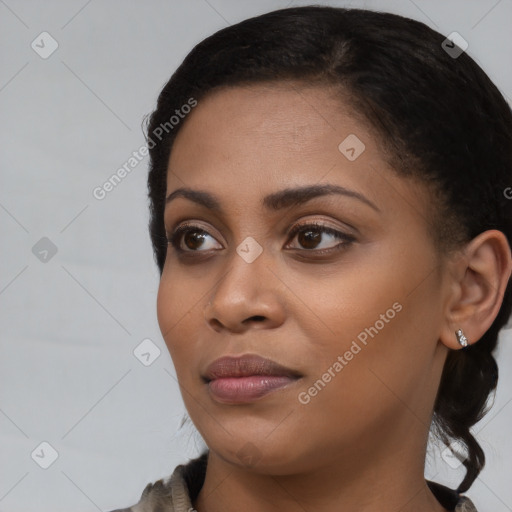 Joyful black young-adult female with medium  brown hair and brown eyes