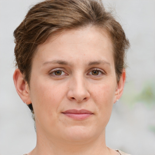 Joyful white adult female with short  brown hair and grey eyes