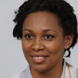 Joyful black adult female with short  brown hair and brown eyes