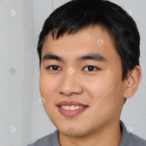 Joyful asian young-adult male with short  black hair and brown eyes