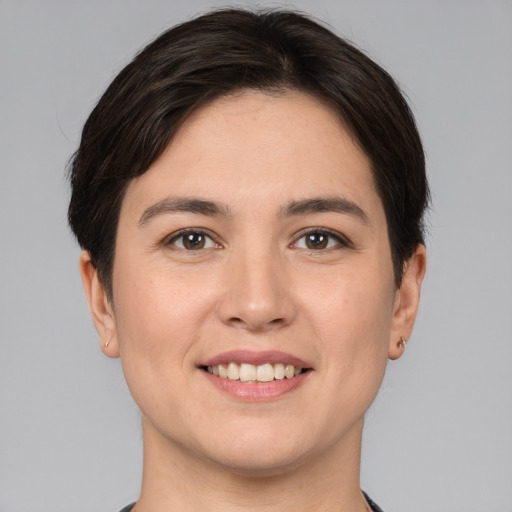 Joyful white young-adult female with short  brown hair and brown eyes