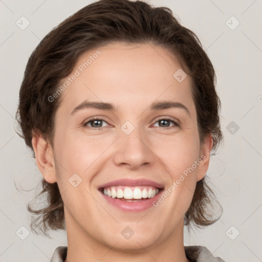 Joyful white young-adult female with medium  brown hair and grey eyes