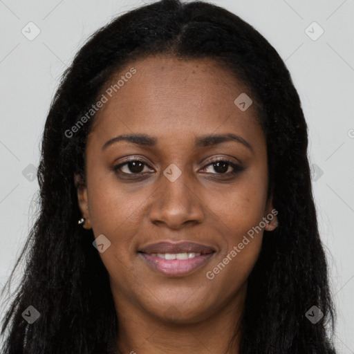 Joyful black young-adult female with long  black hair and brown eyes