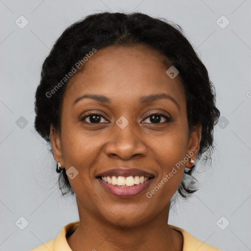 Joyful black adult female with short  brown hair and brown eyes