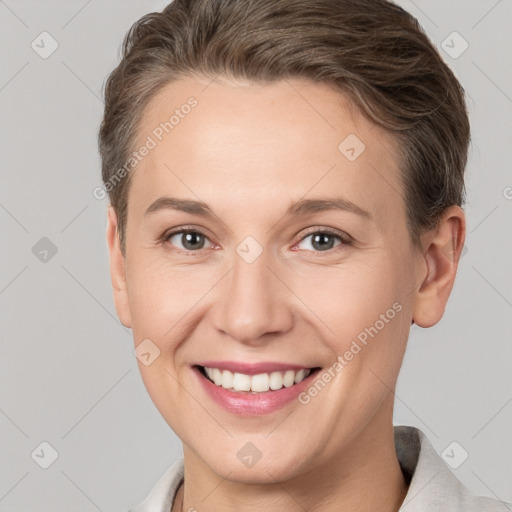 Joyful white young-adult female with short  brown hair and grey eyes