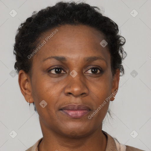 Joyful black adult female with short  brown hair and brown eyes