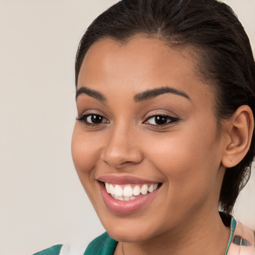 Joyful latino young-adult female with medium  brown hair and brown eyes