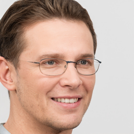 Joyful white adult male with short  brown hair and grey eyes