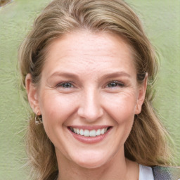 Joyful white young-adult female with medium  brown hair and blue eyes