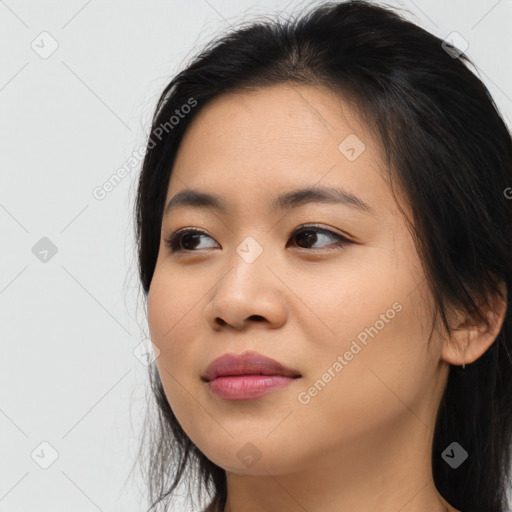 Joyful asian young-adult female with long  brown hair and brown eyes