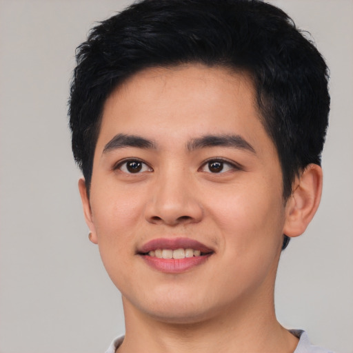 Joyful asian young-adult male with short  black hair and brown eyes