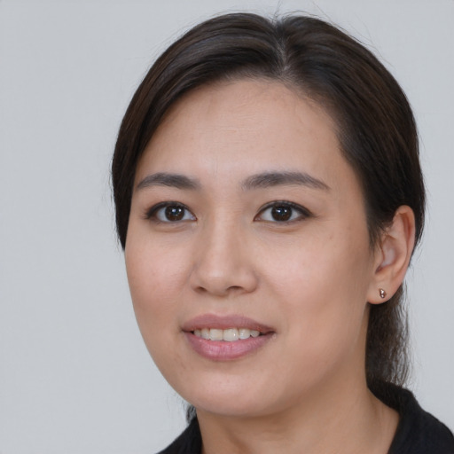 Joyful asian young-adult female with medium  brown hair and brown eyes