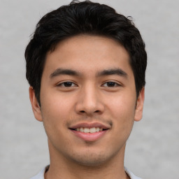 Joyful asian young-adult male with short  brown hair and brown eyes