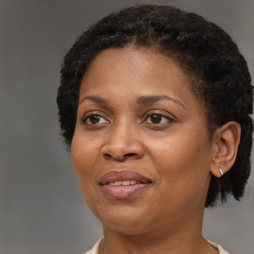 Joyful black adult female with medium  brown hair and brown eyes