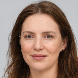 Joyful white adult female with long  brown hair and brown eyes