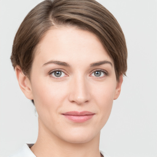 Joyful white young-adult female with short  brown hair and grey eyes