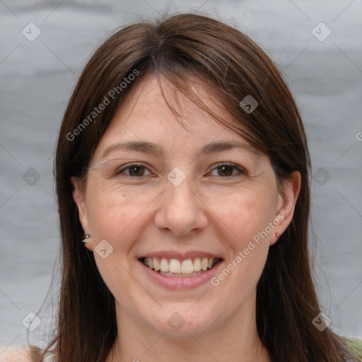 Joyful white adult female with long  brown hair and brown eyes