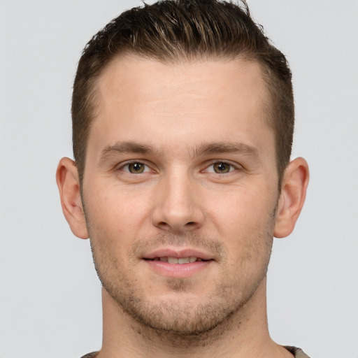 Joyful white young-adult male with short  brown hair and grey eyes