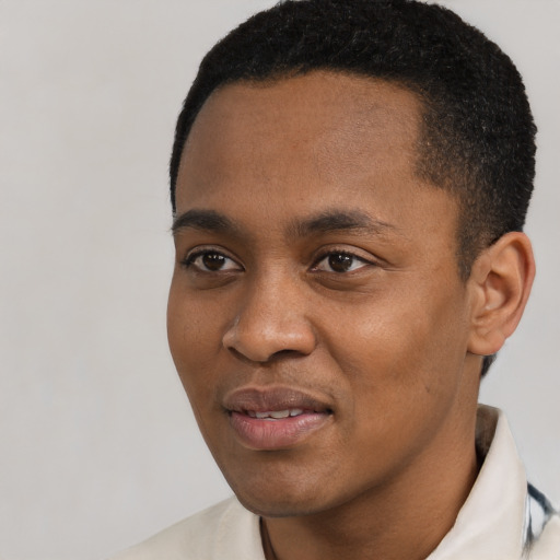 Joyful black young-adult male with short  black hair and brown eyes