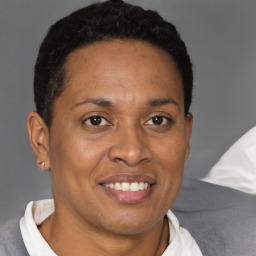 Joyful black adult female with short  brown hair and brown eyes