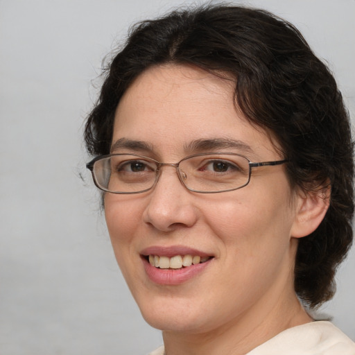 Joyful white adult female with medium  brown hair and brown eyes