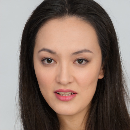 Joyful asian young-adult female with long  brown hair and brown eyes