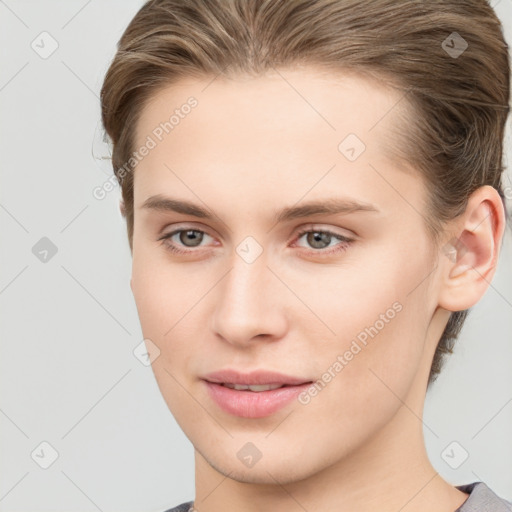 Joyful white young-adult female with short  brown hair and grey eyes