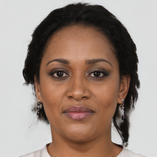 Joyful black adult female with medium  black hair and brown eyes