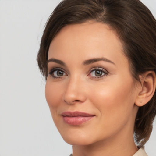 Joyful white young-adult female with medium  brown hair and brown eyes