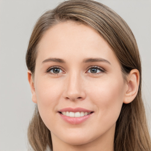 Joyful white young-adult female with long  brown hair and grey eyes