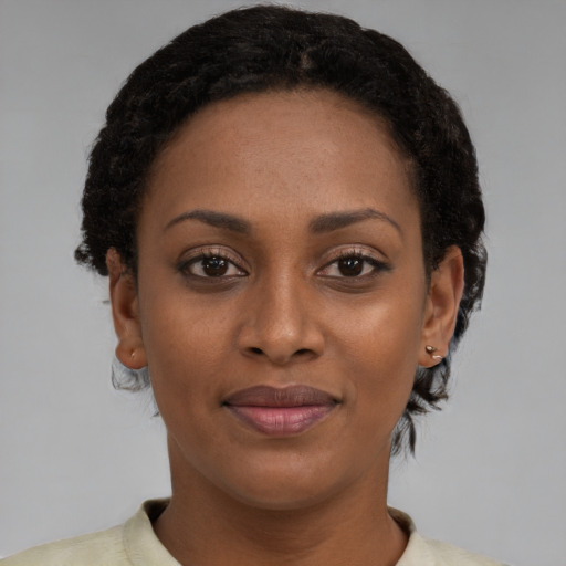Joyful black young-adult female with short  brown hair and brown eyes