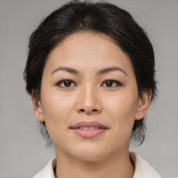 Joyful asian young-adult female with medium  brown hair and brown eyes