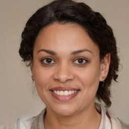 Joyful latino young-adult female with medium  brown hair and brown eyes