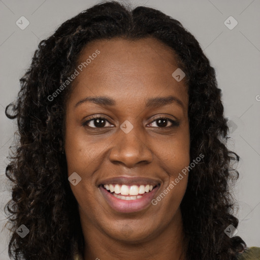 Joyful black young-adult female with long  brown hair and brown eyes