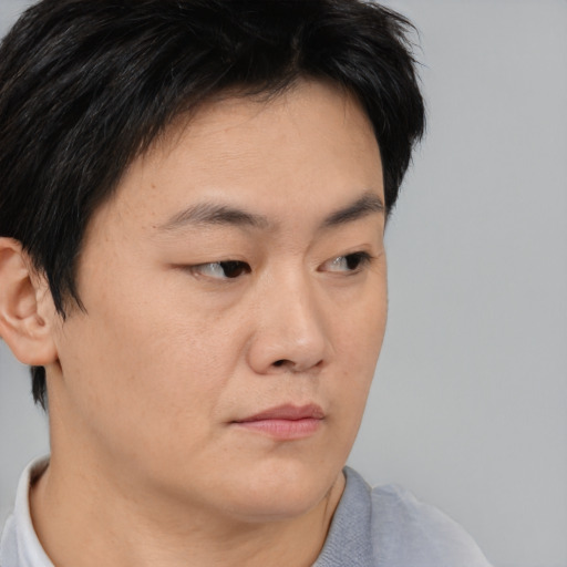 Neutral asian young-adult male with short  brown hair and brown eyes