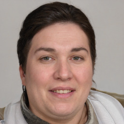 Joyful white adult female with medium  brown hair and blue eyes