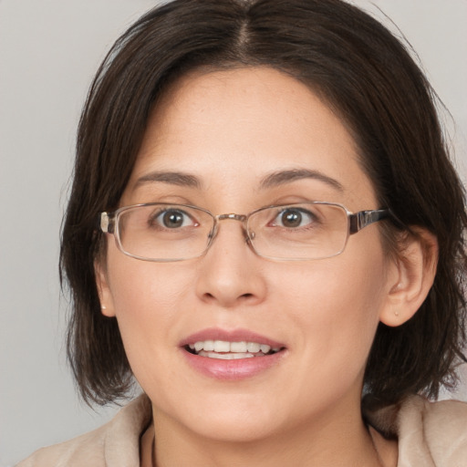 Joyful white adult female with medium  brown hair and brown eyes