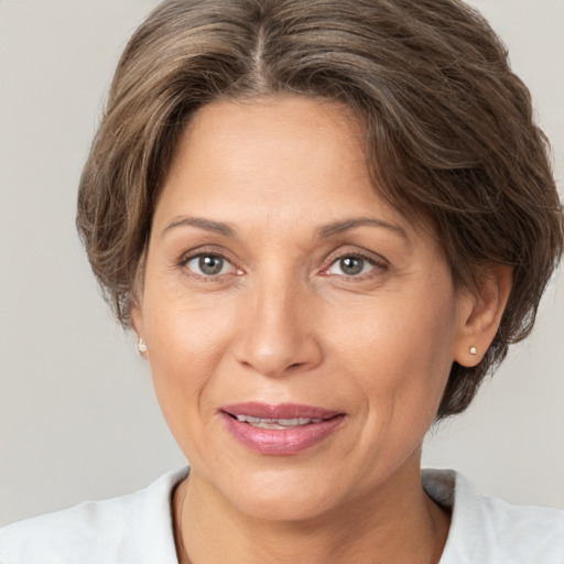 Joyful white adult female with short  brown hair and brown eyes