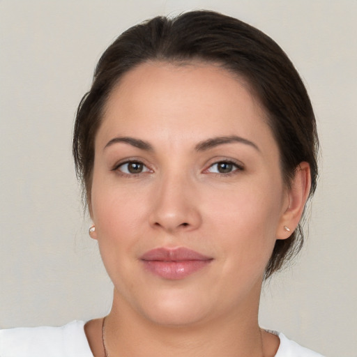 Joyful white young-adult female with medium  brown hair and brown eyes