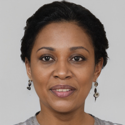 Joyful black adult female with short  brown hair and brown eyes