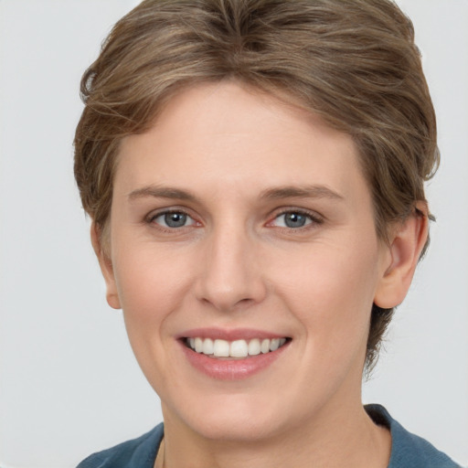 Joyful white young-adult female with short  brown hair and grey eyes