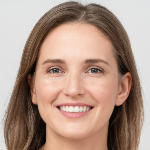 Joyful white young-adult female with long  brown hair and grey eyes