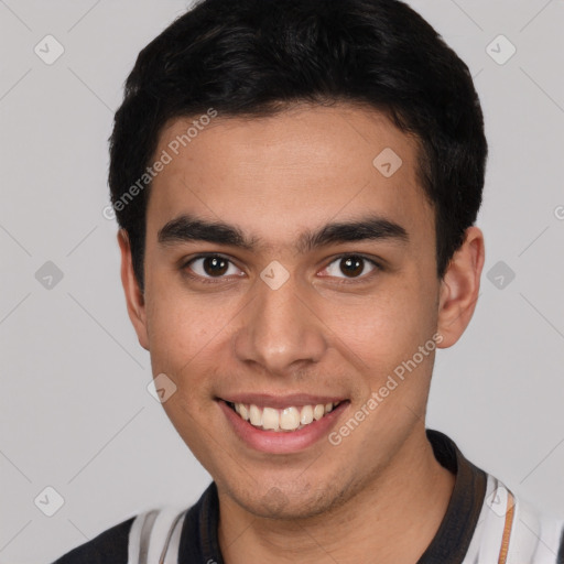 Joyful white young-adult male with short  black hair and brown eyes