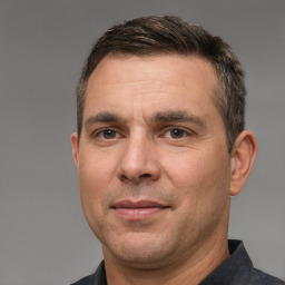 Joyful white adult male with short  brown hair and brown eyes