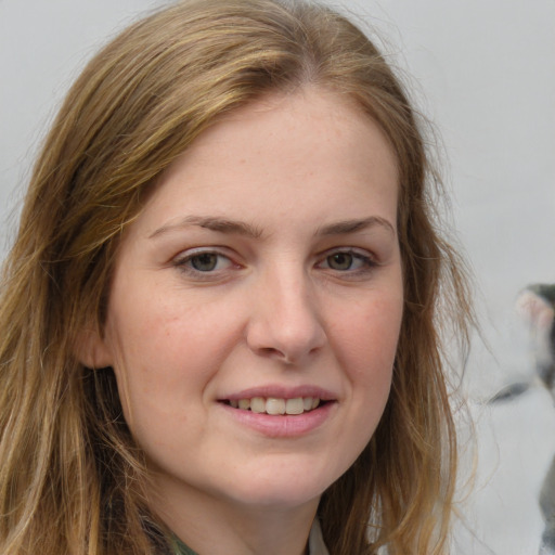 Joyful white young-adult female with long  brown hair and grey eyes