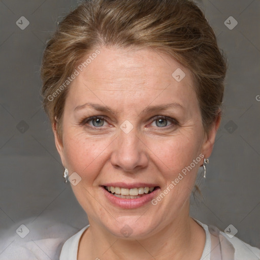 Joyful white adult female with short  brown hair and grey eyes