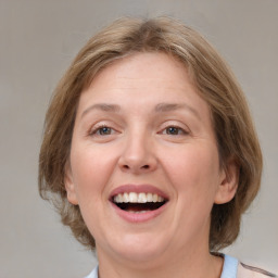 Joyful white adult female with medium  brown hair and grey eyes