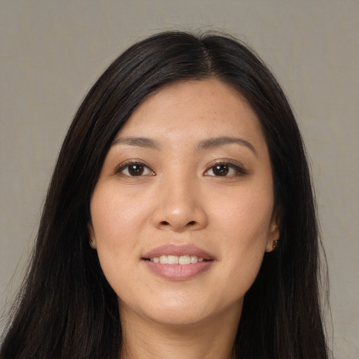 Joyful asian young-adult female with long  black hair and brown eyes